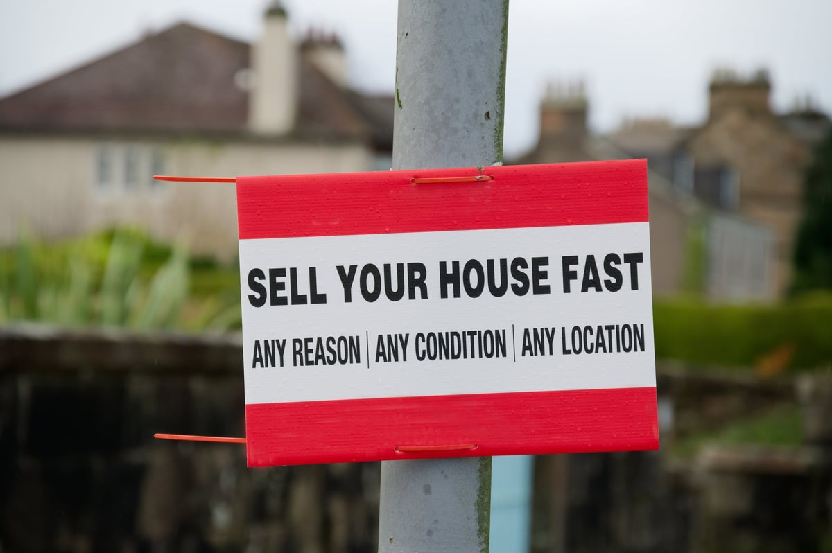 Sell your house fast sign outside a residential area